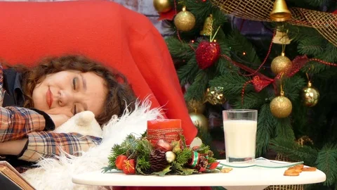 A dog eats a liver and drinks milk next to a sleeping girl Stock Footage 83413040