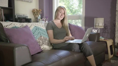 Dog jumping up on the couch with owner Stock Footage