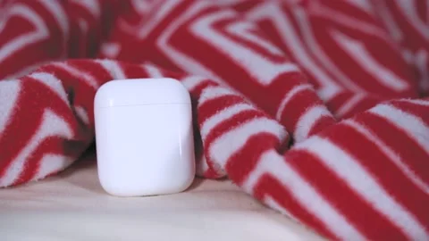 Dog paw opens charging case for modern gadget - wireless headphones laying on Stock Footage 138115979