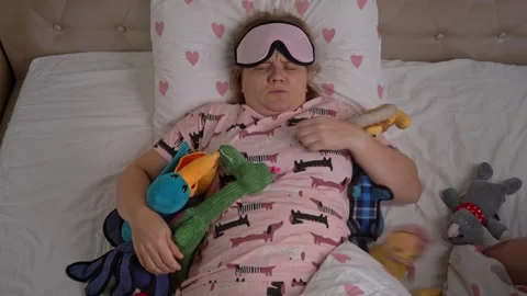 Dog pulls blanket from sleeping owner, looks for toy, wakes him up Raising puppy Video stock 250139558