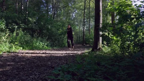 The dog runs after the guy Stock Footage 142494378