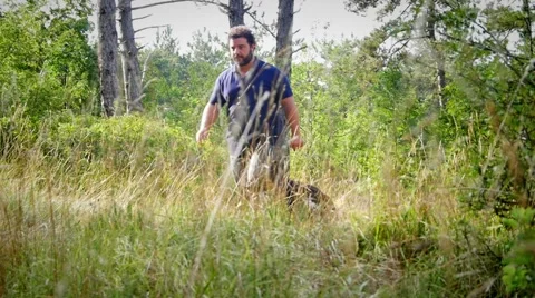 Dog trainer and german shepherd in the woods Stock Footage 59964474