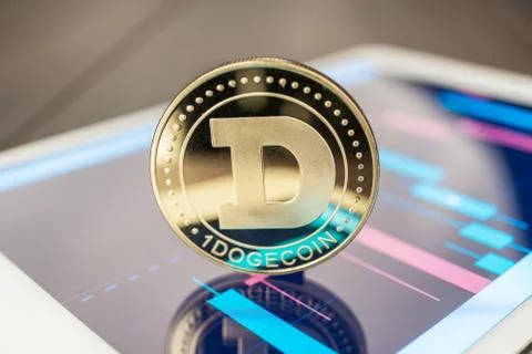 Dogecoin cryptocurrency on the tablet Stock Photos