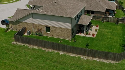 Dogs playing and looking at Drone camera in suburban Backyard Stock Footage 114955965