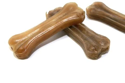 Dog's pressed chew bones made of rawhide over white Stock Photos