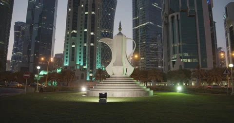 Doha, Qatar - Big tea pot monument and Downtown buildings at sunset. Video stock 221872528