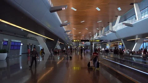 Doha. Qatar - July, 8, 2019: People walking in Hamad International airport and u Stock Footage 120141082