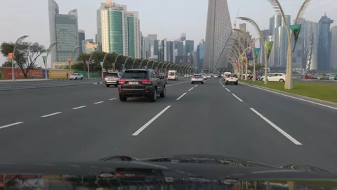 Doha, Qatar - Mar 22, 2024: Traffic jam drive at Corniche financial centre in Video stock 300310670
