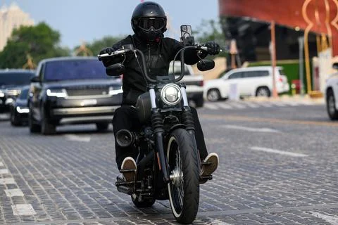 Doha - Qatar - March 19, 2024: A motorcycle driver riding a sports bike Stock Photos