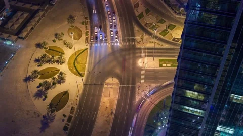 DOHA, QATAR - OCTOBER 25, 2024: Busy intersection at night showcasing traffic Stock-Footage 289831385