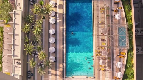 DOHA, QATAR - OCTOBER 25, 2024: Aerial view of a vibrant pool area with Stock Footage 289832373
