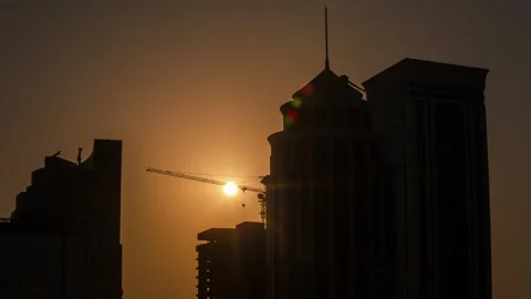 DOHA, QATAR - OCTOBER 25, 2024: Sunset silhouetted against skyscrapers and 스톡 동영상 289833165