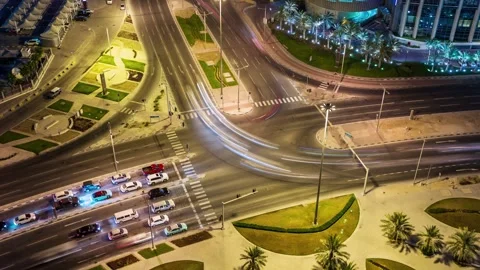 DOHA, QATAR - OCTOBER 25, 2024: Busy intersection illuminated by city lights Stock Footage 289833454