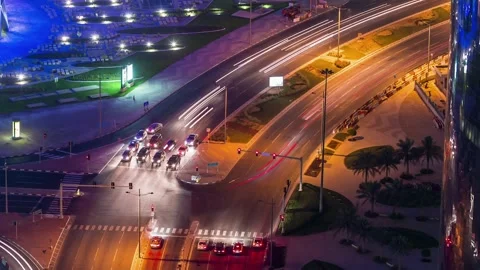 DOHA, QATAR - OCTOBER 25, 2024: Nighttime city view showcasing bustling traffic Stock Footage 289836147