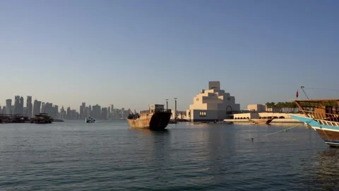 Doha Skyline and Museum of Islamic Art with Dhow Boats Stock Footage 336564154
