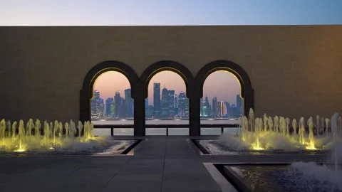 Doha Skyline Framed Through MIA Arches with Fountains at Dusk, Qatar Stock Footage 337771555