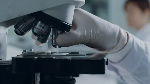 Doing analysis with microscope Stock Footage 125649884