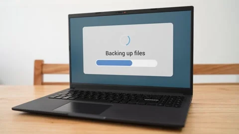 Doing backup of personal files on laptop. Concept of cloud storage backups. Stock Footage 310296219