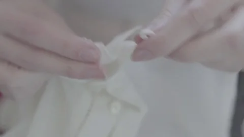 Doing Up Buttons Stock Footage 79576675