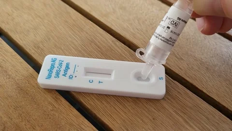 Doing a COVID-19 antigen test that turns negative, 4K Stock Footage 260478966