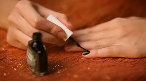 Doing her manicure with black nail polish Stock Footage 10585256