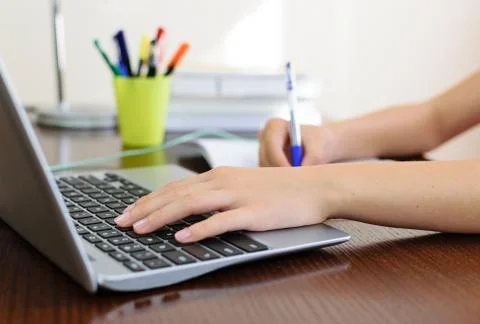 Doing homework on a laptop Stock Photos