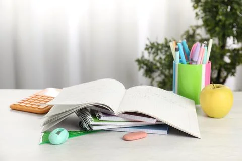 Doing homework. Notebook with math assignment, apple and stationery on whit.. Stock Photos