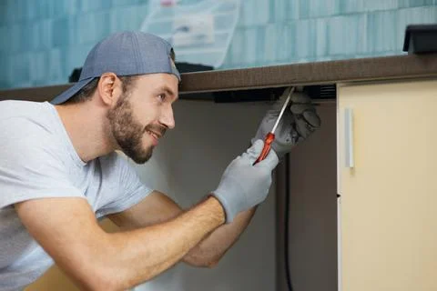 Doing it right. Portrait of young repairman, professional plumber looking Foto stock