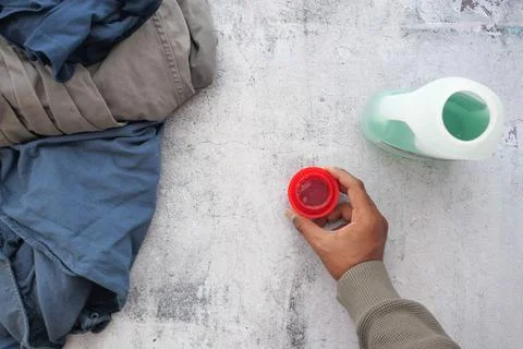 Doing laundry with detergent and clothes Stock Photos