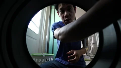 Doing Laundry Through the Washing Machine Window Stock Footage 318914031