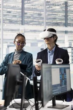 Doing microchip yield enhancement, VR headset and engineering team Stock Photos