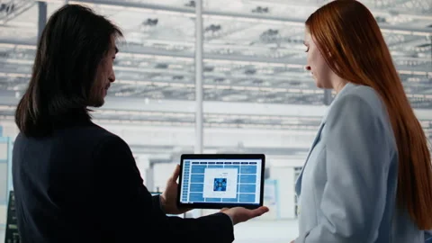 Doing microchips yield enhancement, tablet and senior manager with worker Stock Footage 335880614