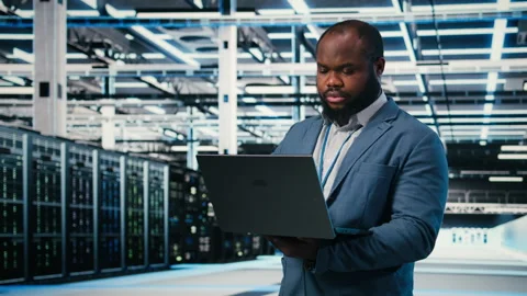 Doing network management, laptop and software developer in server farm. Stock Footage 330140013
