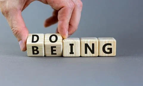 Doing or being symbol. Concept word Doing and Being on wooden cubes. Busine.. Stock Photos
