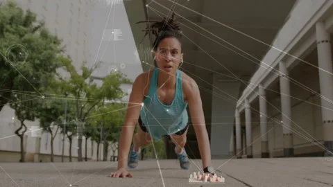 Doing push-ups, woman exercising outdoors with data processing animation over 動画素材 305620336