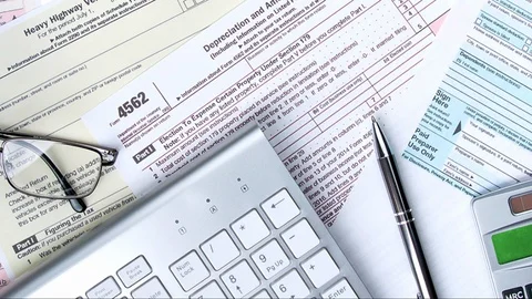Doing Taxes Online with Computer and Calculator Stock Footage 123318934