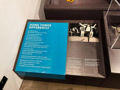 Doing things differently museum exhibit panel about Manchester, UK music hi.. Stock Photos