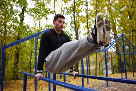 Doing Triceps Dips on Parallel Bars Stock Photos