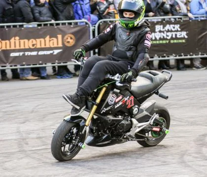 Doing tricks on a bike. Stock Photos