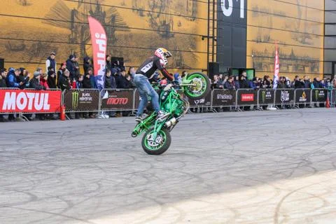 Doing the tricks on a motorcycle. Stock Photos
