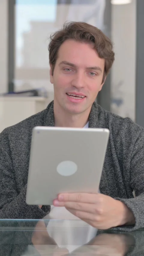 Doing Video Chat on Tablet in Office, vertical video Stock Footage 324792796
