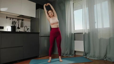 Doing a Yoga Pose in the Kitchen Vídeos de archivo 306017772