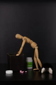 Doll and narcotic substances composition on a dark background. The concept of Stock Photos