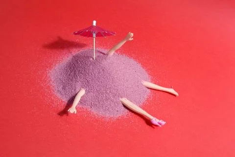 Doll and pink sand Stock Photos