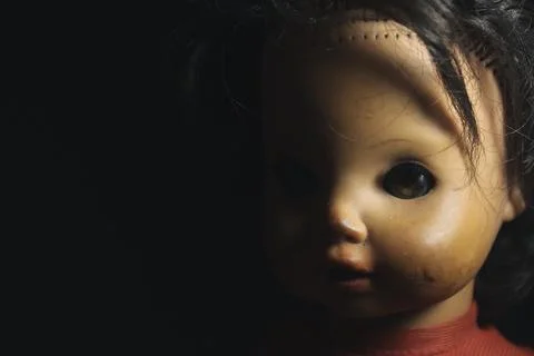 Doll on black Foto stock