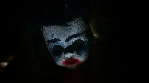 Doll in flickering light Stock Footage 135387807