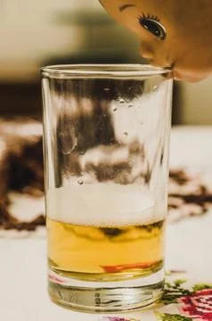 A doll with a glass. Stock Photos