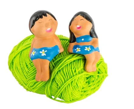 Doll on green yarn Stock-Fotos