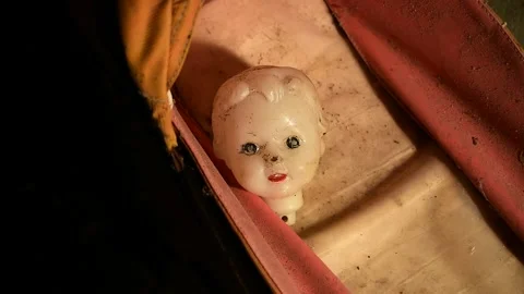 Doll head in the glancing light of a lantern Stock Footage 143258677