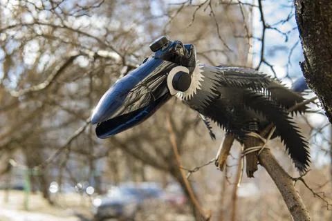 Doll made of empty plastic bottles near a tree. plastic recycling concept. Stock Photos